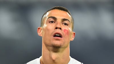 Cristiano Ronaldo wearing red face paint to raise awareness of domestic violence against women. Reuters