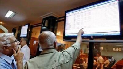 Iraqis watch stock performance at Baghdad's stock exchange. AFP