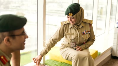 Officers Laila Mohammed Bilkhairi and Yousef Hassan Abdul Nasser play a game of chess.
