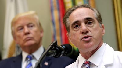 Donald Trump listens as the former secretary of veterans affairs David Shulkin speaks at the White House in Washington, U.S., August 3, 2017. REUTERS/Joshua Roberts