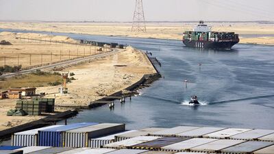 A Suez Canal Authority pilot vessel, centre, navigates a convoy of container ships as they pass southbound along the Suez Canal in Egypt. Kristian Helgesen / Bloomberg