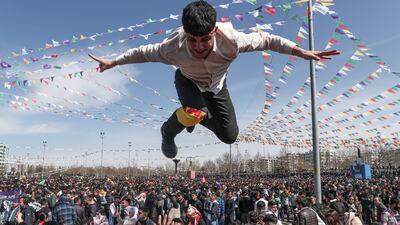 Is he flying? No, this young Kurdish man is being thrown into the air by his friends at a rally, part of Nowruz — Kurdish New Year — celebrations in Diyarbakir, Turkey. EPA