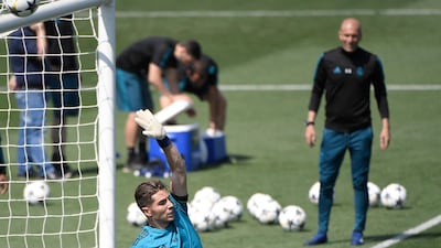 Zinedine Zidane looks at his son, goalkeeper Luca Fernandez, as they attend a training session. Gabriel Bouys / AFP