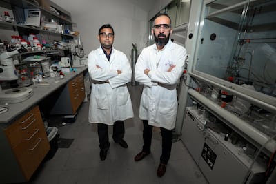 Dr Ali Trabolsi, pictured with colleague, Prakasam Thirumurugan, examined methods to reduce the side effects of cancer care. Chris Whiteoak / The National