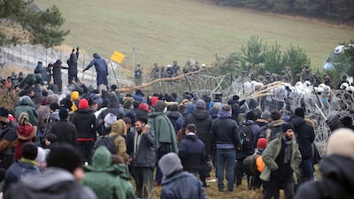 People gather at the EU border near Grodno, Belarus. AP