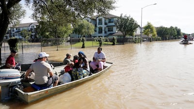 A family is evacuated by boat from Tropical Storm Harvey floodwaters in western Houston, Texas on August 30, 2017. Rick Wilking/ Reuters