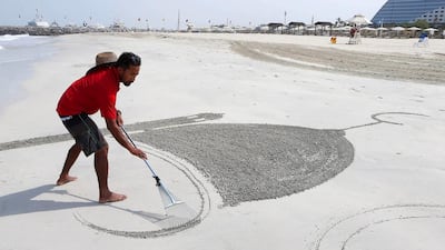 Nathaniel Alapide makes his Eid drawing at Jumeirah Beach hotel in Dubai. Pawan Singh / The National