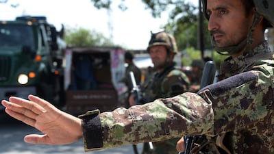 Afghan soldiers search vehicles at a checkpoint in Jalalabad a day after ISIS militants attacked a government office in the eastern city. AFP