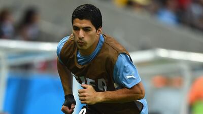 Luis Suarez warms up on the sideline during Uruguay's 2014 World Cup opener against Costa Rica on Saturday. Uruguay face England on Wednesday. Laurence Griffiths / Getty Images / June 14, 2014