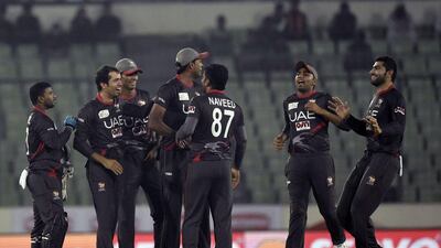 United Arab Emirates cricketers ( Fahad Tariq 2nd right) react after the dismissal of the Sri Lanka cricketer Angelo Mathews (L) during the match between Sri Lanka and United Arab Emirates at the Asia Cup T20 cricket tournament at the Sher-e-Bangla National Cricket Stadium in Dhaka on February 25, 2016. AFP PHOTO/Munir uz ZAMAN