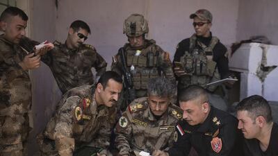 Iraqi special forces Lt Gen Abdul Wahab Al Saadi, centre, and his team monitor ISIL positions in the Old City of Mosul, Iraq on June 27, 2017. Felipe Dana/AP Photo