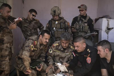 Iraq’s most senior counter-terrorism officer Gen Abdul Wahab Al Saadi, centre, works with a team to root out ISIS. AP