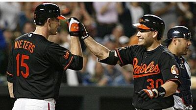 The hitting of Baltimore Orioles' Luke Scott, right, overshadowed the debut of teammate Matt Wieters against the Detroit Tigers.