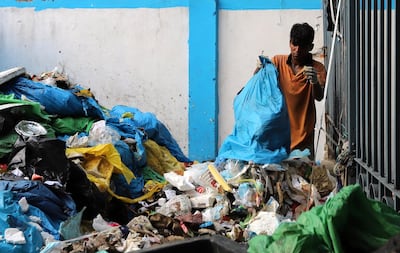 A worker empties a bag of biomedical waste near Lok Nayak Hospital in New Delhi. Getty