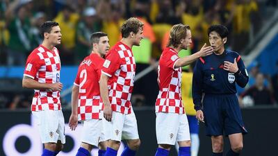 Referee Yuichi Nishimura, right, is pursued by Dejan Lovren, Sime Vrsaljko, Nikica Jelavic and Ivan Rakitic of Croatia after awarding a penalty kick during the 2014 World Cup Group A match between Brazil and Croatia at Arena de Sao Paulo on June 12, 2014. Christopher Lee / Getty Images