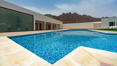 The pool at The Palm House comes with mountain views