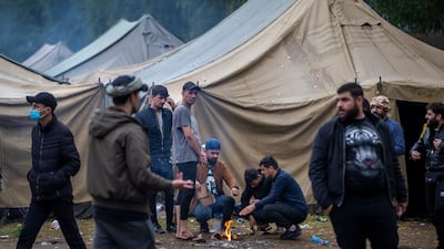 Migrants prepare food at the newly built refugee camp in the Rudninkai military training ground, some 38km (23,6 miles) south from Vilnius, Lithuania. AP