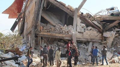 People gather around a hospital supported by Medecins Sans Frontieres near Maaret Al Numan in Syria’s Idlib province after it was destroyed by air strikes on Febrary 15, 2016. Ghaith Omran / / Al Maarra Today / AFP