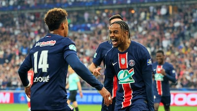 Paris Saint-Germain's Bradley Barcola celebrates scoring their second goal against Stade de Reims with Desire Doue. Reuters