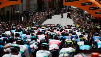 Cyclists and fans crowd the street at the start of Stage 11 in Perugia. AP