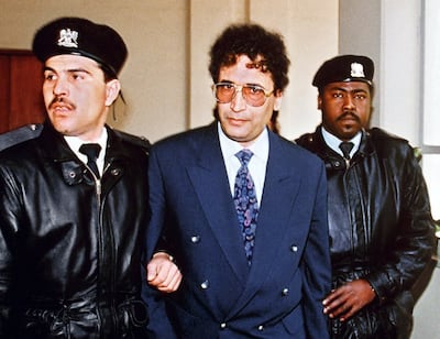A file picture taken on February 18, 1992 in Tripoli shows convicted Lockerbie bomber Abdelbaset Al Megrahi being escorted by security officers. AFP