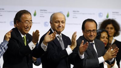 United Nations Secretary General Ban Ki-Moon and other leaders applaud after the final conference at COP21 (AP Photo/Francois Mori)
