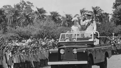 Queen Elizabeth II and Prince Philip ride an open-top Land Rover during a visit to Fiji in 1963. The Duke of Edinburgh has long been associated with the marque. Getty Images