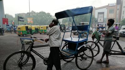 Rickshaw pullers wait for passengers outside a metro station in New Delhi as air quality continues to remain in hazardous category. Taniya Dutta for The National