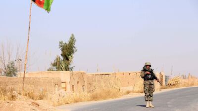 An Afghan soldier stands guard at a check point in Helmand. The US has massively stepped up its air offensive in Afghanistan, targeting Taliban drug labs and ISIL hideouts. Watan Yar / EPA