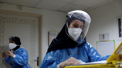A nurse wearing a protective suit and mask checks the files at Hazrate Ali Asghar Hospital in Tehran, Iran. REUTERS