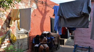 Ganga Kalshetty (C), 12, diagnosed with the early signs of leprosy, sits with her friends as they study in a leprosy colony.