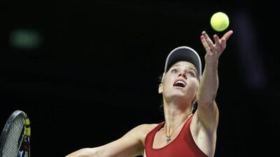 Caroline Wozniacki serves to Agnieszka Radwanska in their match at the WTA Finals on Thursday in Singapore. Wallace Woon / EPA / October 23, 2014