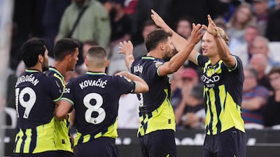 City's Erling Haaland celebrates his hat-trick with teammates. The Norwegian has seven goals in three Premier League games this season. PA