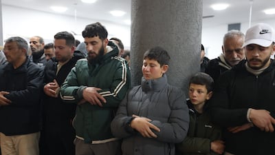 Relatives pray at the funeral of the Bani Odeh family in Tammun, in the occupied West Bank. EPA