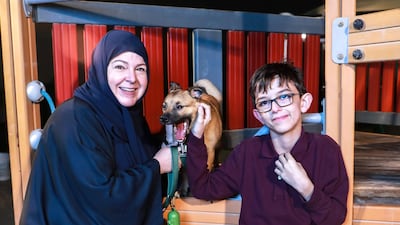 Khawla Barley says her son, 11-year-old Abdulla Al Mansouri, has bonded closely with his pet dog Finn despite early efforts to separate them Victor Besa / The National