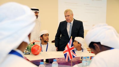 Prince Andrew , Duke of York, centre, talks to the students of Zayed Al Thani School during his visit to “The Make it Challenge” an initiative to design, create , cost and market an unmanned rescue vehicle held at the Khalifa University in Abu Dhabi. Pawan Singh / The National