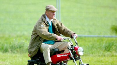 The Duke of Edinburgh rides on his mini motorbike during the Royal Windsor Horse Show at Home Park, Windsor Castle, in 2005. Julian Finney/Getty Images