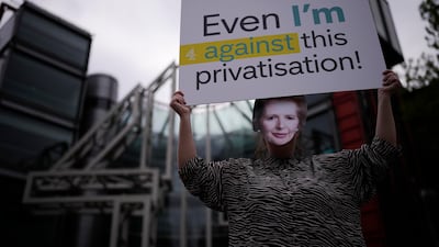 A campaigner from We Own It poses in a Margaret Thatcher mask to protest against the privatisation of Channel 4 in London, in April 2022. AP