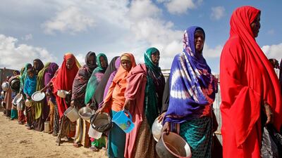 Women who fled drought queue for food at a camp for displaced people on the outskirts of the Somali capital Mogadishu. AP