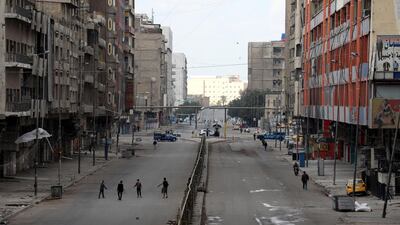 Iraqi police block access to a main road during the latest lockdown in central Baghdad. EPA