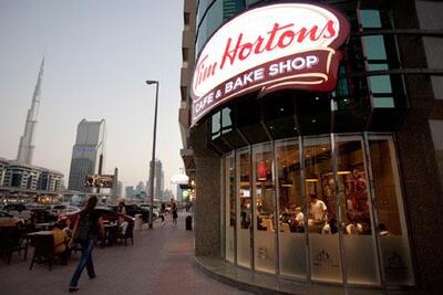 Customers wait in line at Tim Hortons coffee shop in Dubai, the first to open in the UAE.