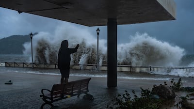 A man takes photograph at the seafront in Hong Kong. Getty Images