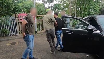 Hewa Rahimpur being detained in an NCA operation in Wanstead Park, east London. PA