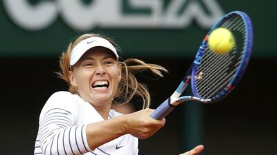 Maria Sharapova of Russia plays a shot to Kaia Kanepi of Estonia during their women's singles match at the French Open tennis tournament at the Roland Garros stadium in Paris, France, May 25, 2015. REUTERS/Jean-Paul Pelissier