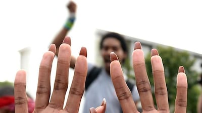 A woman displays her hands during a rally/prayer vigil at Marshall Park in Charlotte, North Carolina. With officials refusing to release any video of the Tuesday shooting of 43-year-old Keith Lamont Scott, anger built as two starkly different versions emerged: Police say Scott disregarded repeated demands to drop his gun, while neighbourhood residents say he was holding a book, not a weapon, as he waited for his son to get off the school bus. The protest started as a downtown prayer vigil, but an angry group left the peaceful event and marched through downtown Charlotte. Jeff Siner / The Charlotte Observer via AP