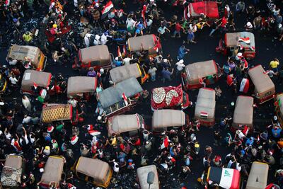 Demonstrators and tuk-tuk drivers take part in an anti-government protests in Baghdad. Reuters