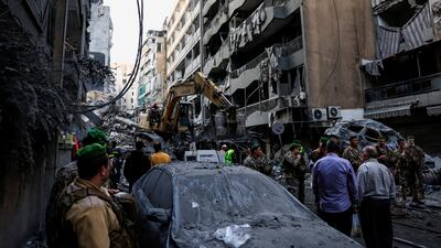Civil defence members work as Lebanese army soldiers stand guard in Beirut's Basta neighbourhood. Reuters