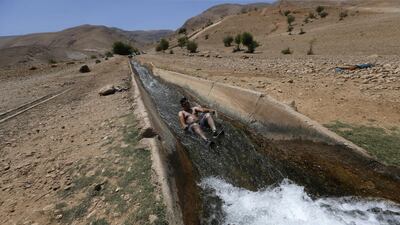 A Palestinian man cools himself in a spring in the Jordan Valley near the Palestinian village of Ouja. EPA
