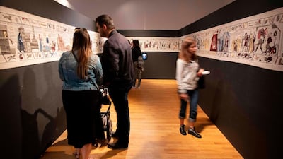 Members of the public look at completed sections of a tapestry depicting the hit television series Game of Thrones at the Ulster Museum in Belfast. Like the Bayeux Tapestry, the Game of Thrones Tapestry is woven of fine linen and hand-embroidered, with decorative borders and a central pictorial narrative. It will reach 90m by the end of the final season of the show. AFP