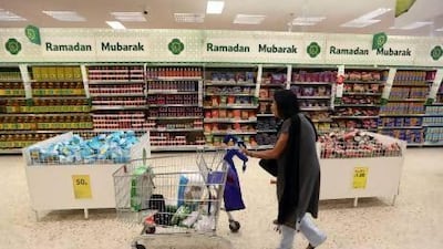A little bit more like home . Eid greeting cards at the Tesco Extra supermarket in North London, which also carries the company's best wishes for Ramadan, and aisles packed with iftar favourites. Stephen Lock / The National